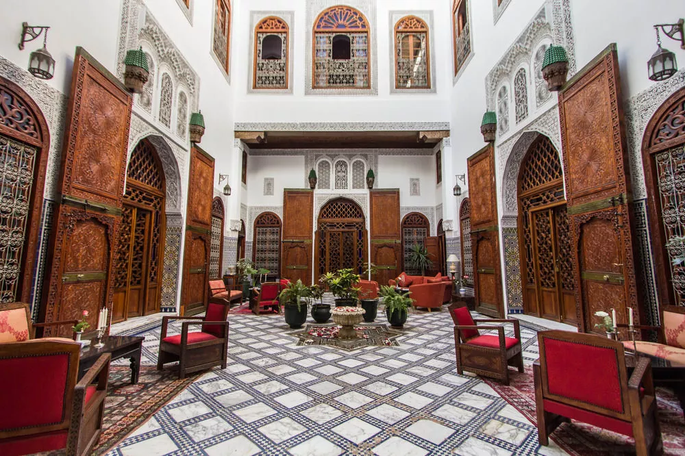 Central courtyard with fountain and carved doors in a Moroccan riad