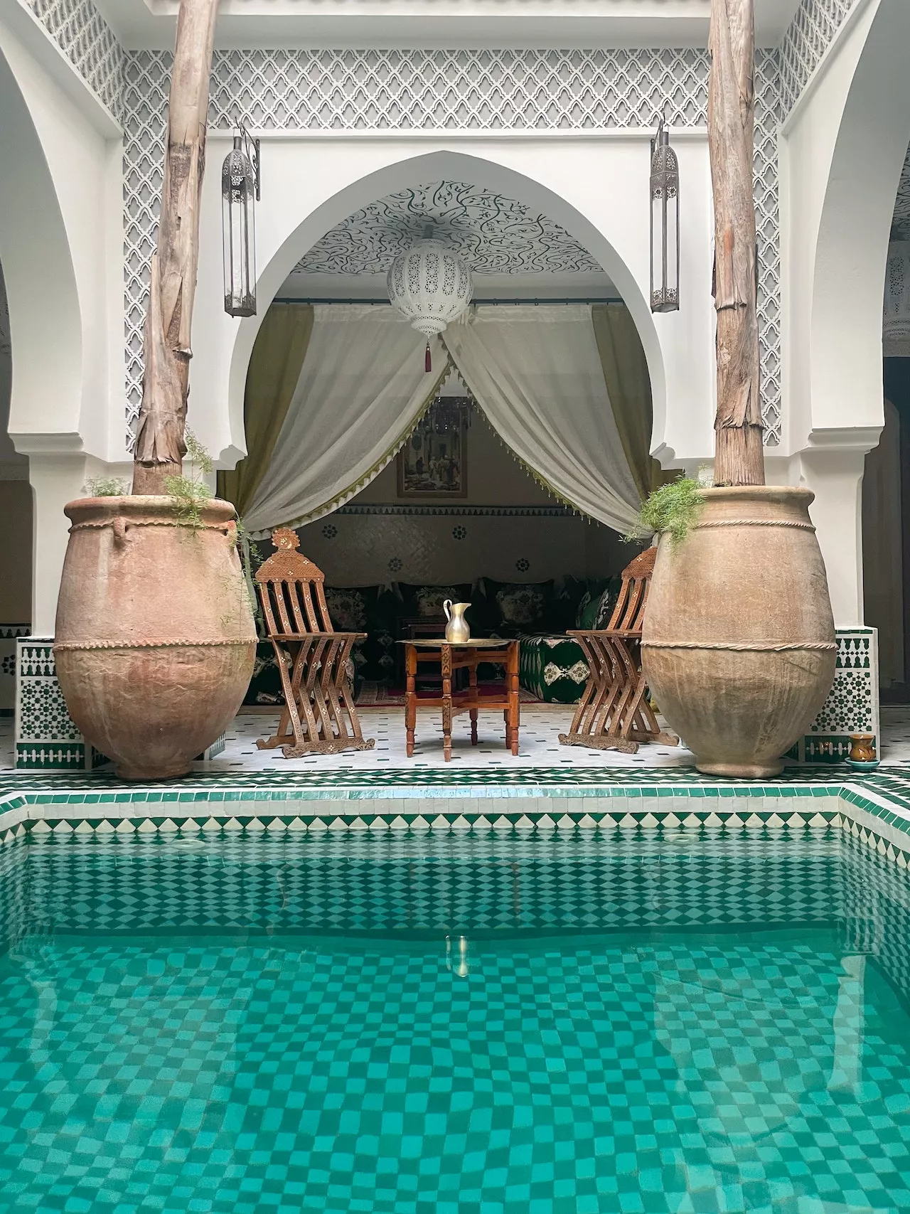 Riad courtyard with turquoise pool and terracotta urns, Marrakech